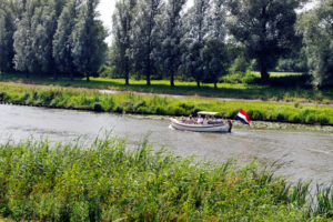 Geldermalsen,,Gelderland,,Holland,,08-15-2012,,Traveler,At,Boat,On,The,River - Stichting Bureau Toerisme